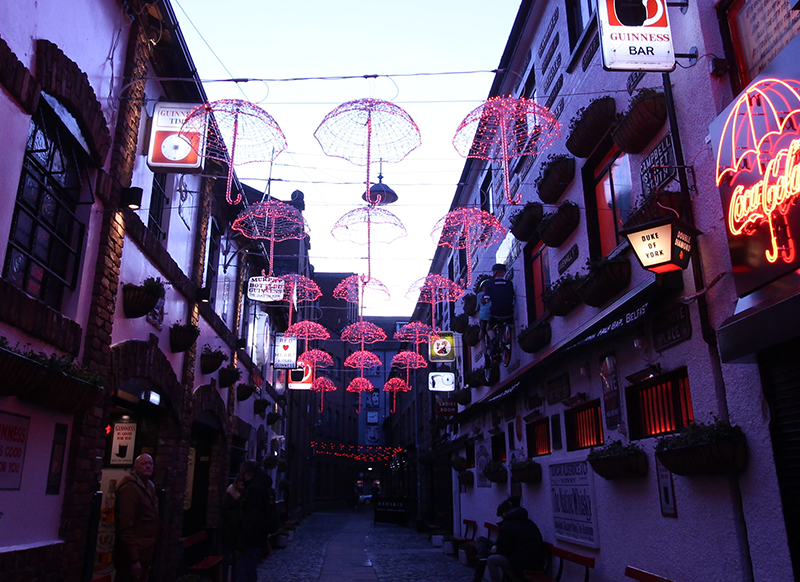 Steet scene showing red umbrellas in Belfast, Ireland